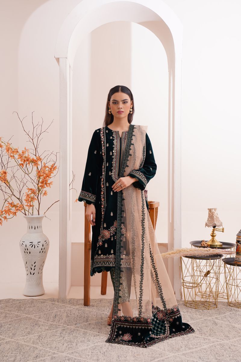 Elegant fashion model in traditional Eastern attire with intricate designs.