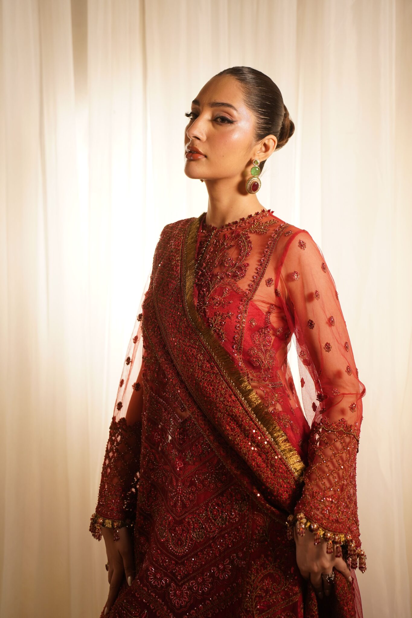 Beautiful fashion portrait of a woman in a luxurious red traditional dress.